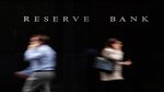 People walking past the Reserve Bank of Australia in Sydney