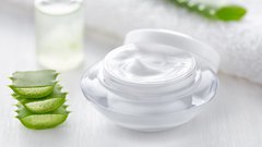 Aloe vera cosmetic cream, herb slices, skin face body care